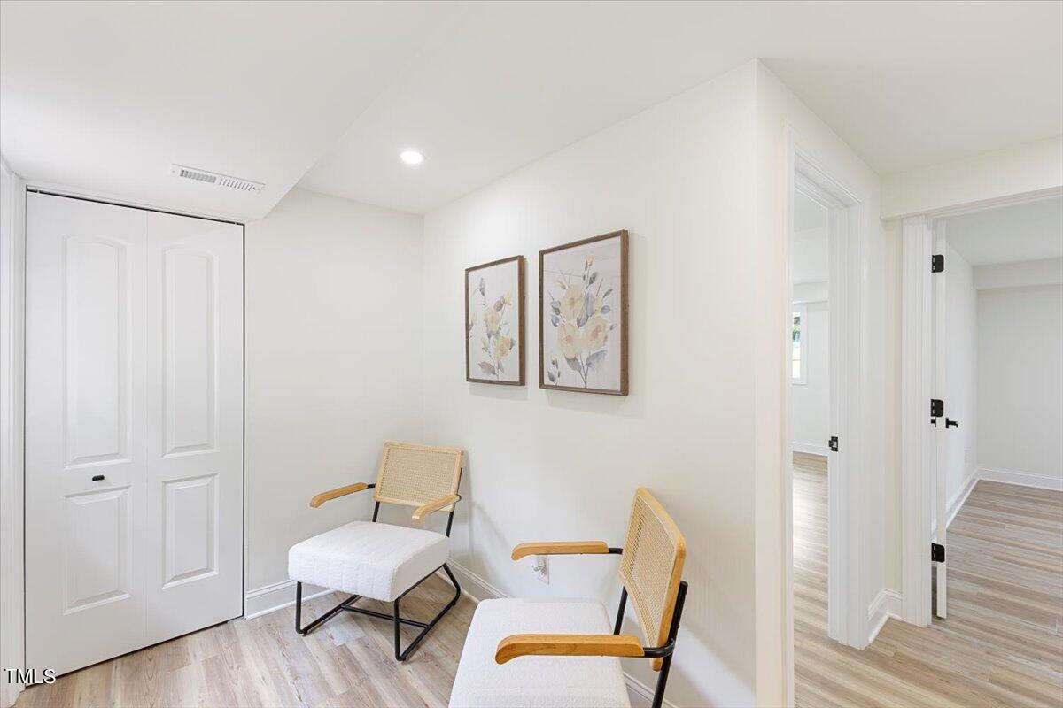 3420 Brentwood Road Raleigh, NC 27604 - Photo 25 of 53 a room with a chair and wooden floor