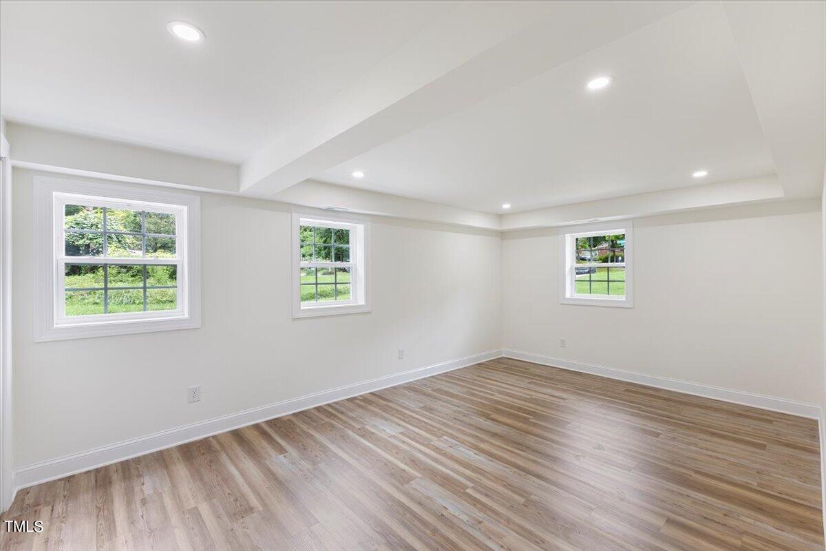 3420 Brentwood Road Raleigh, NC 27604 - Photo 27 of 53 an empty room with wooden floor and windows
