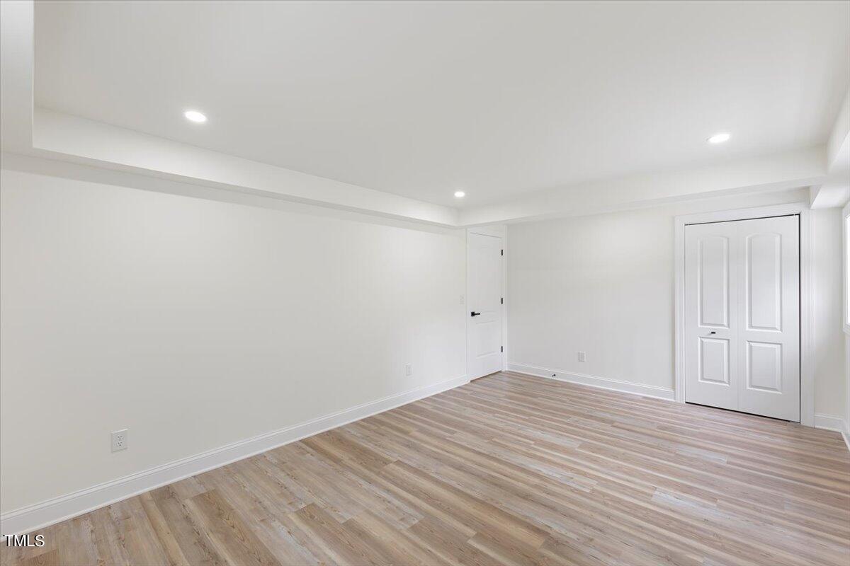 3420 Brentwood Road Raleigh, NC 27604 - Photo 28 of 53 a view of room with wooden floor and white walls