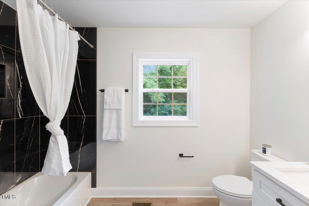 3420 Brentwood Road Raleigh, NC 27604 - Photo 32 of 53 a bathroom with a toilet a sink and a bathtub