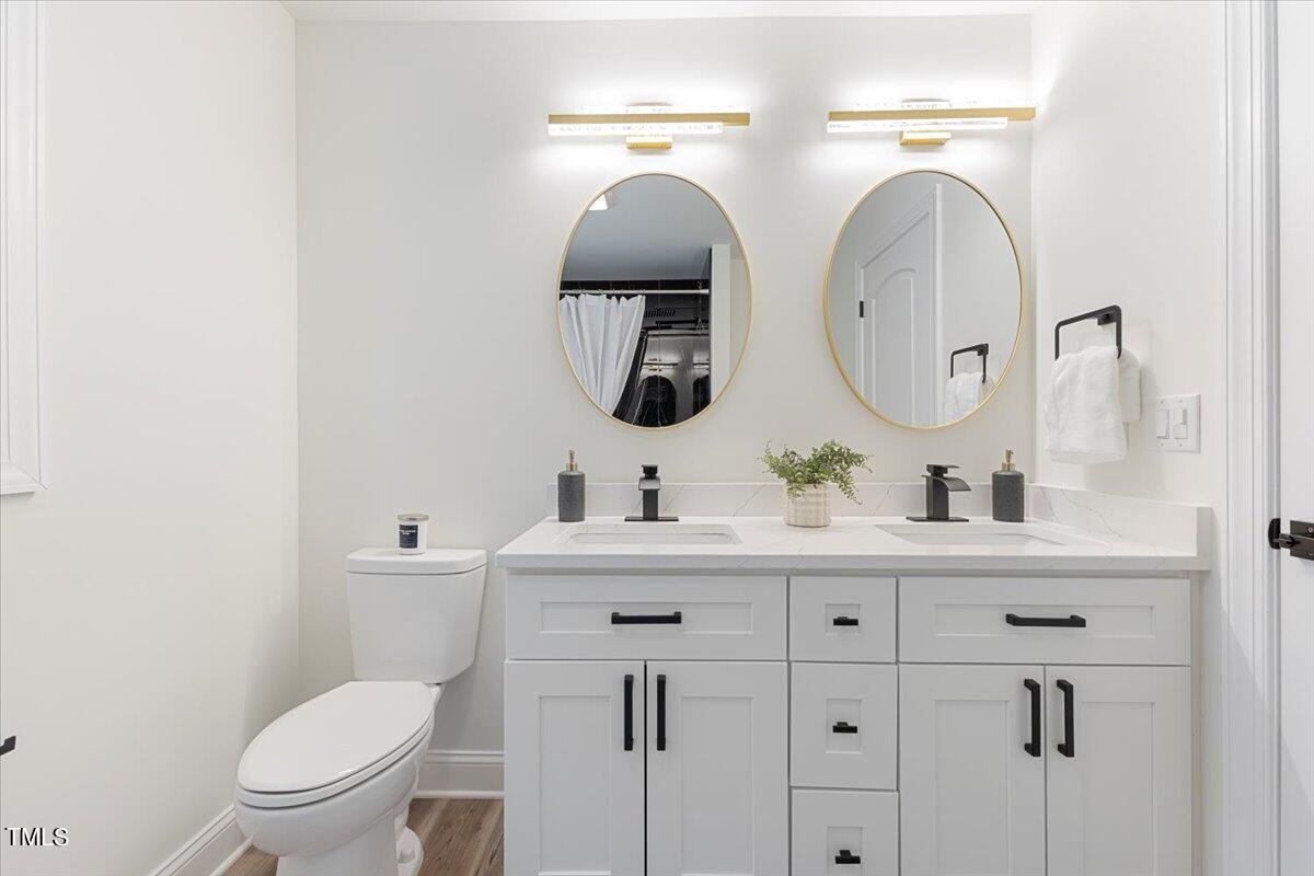 3420 Brentwood Road Raleigh, NC 27604 - Photo 33 of 53 a bathroom with a toilet sink and mirror