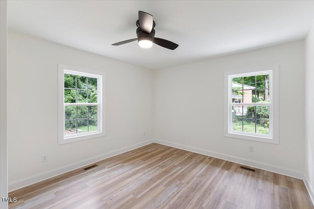 3420 Brentwood Road Raleigh, NC 27604 - Photo 36 of 53 a view of an empty room with wooden floor and a window