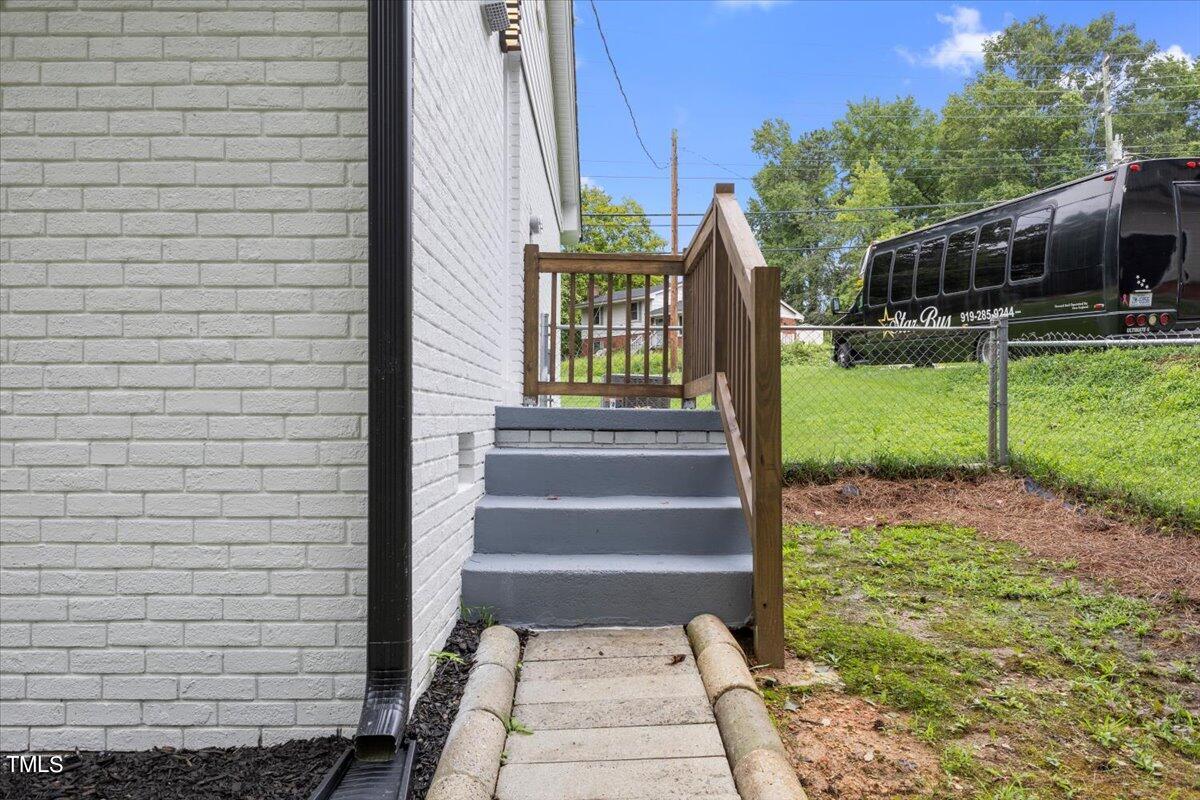 3420 Brentwood Road Raleigh, NC 27604 - Photo 46 of 53 a view of a pathway of a house with a small yard and large trees