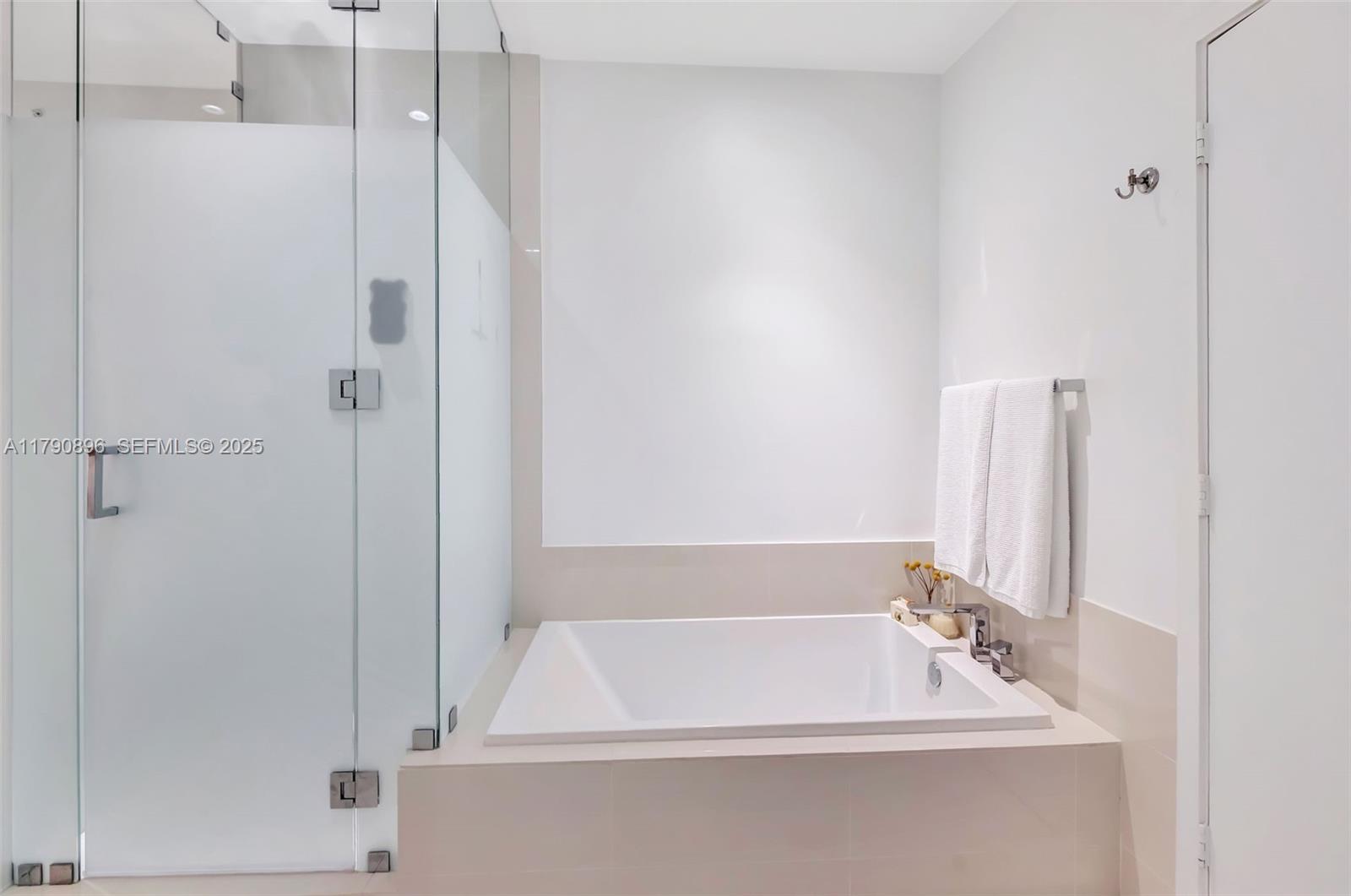 55 Southwest 9th Street, Unit PH4501 Miami, FL 33130 - Photo 22 of 71 a bathroom with a bathtub and a shower