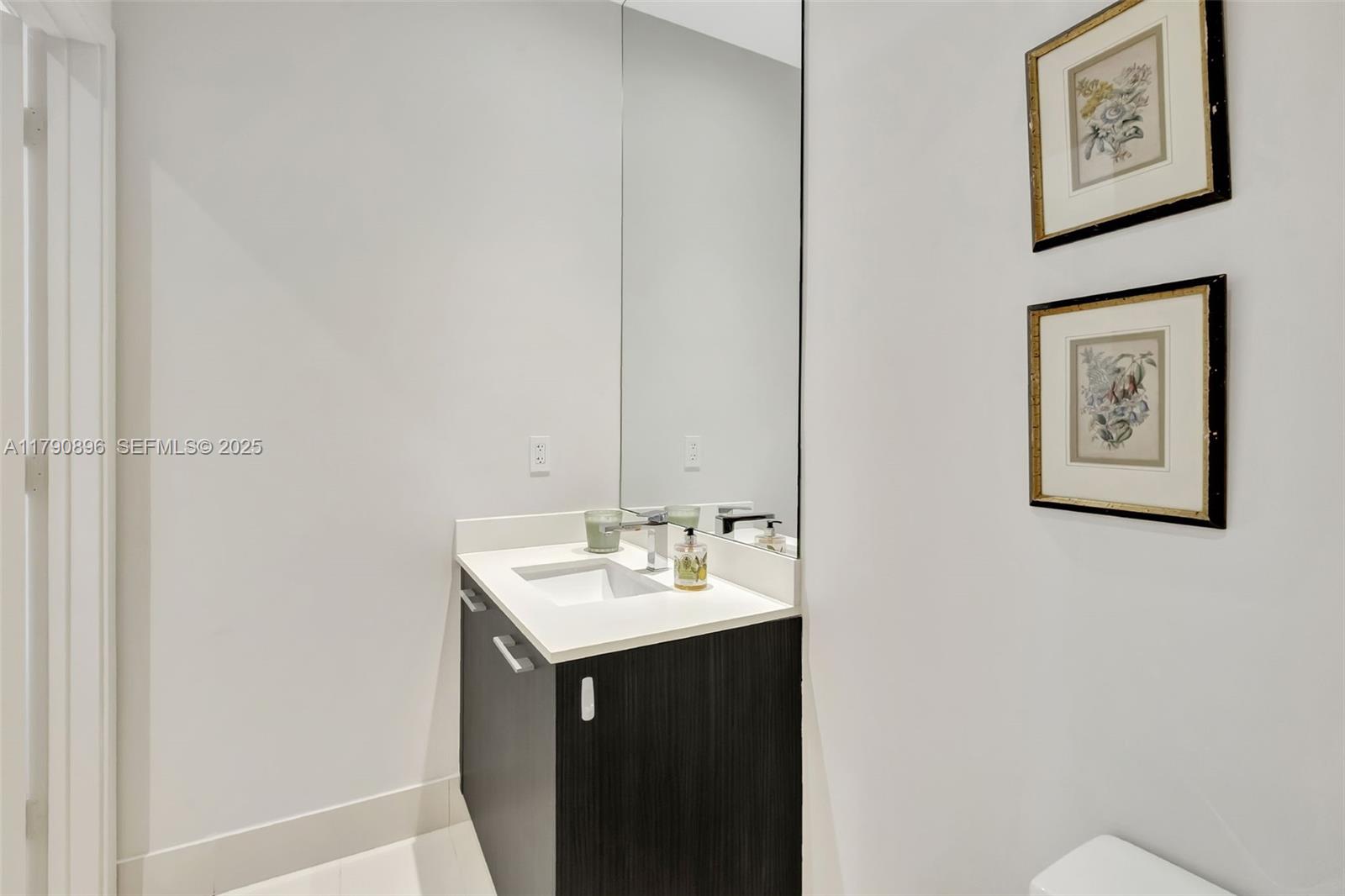 55 Southwest 9th Street, Unit PH4501 Miami, FL 33130 - Photo 29 of 71 a bathroom with a sink and a mirror