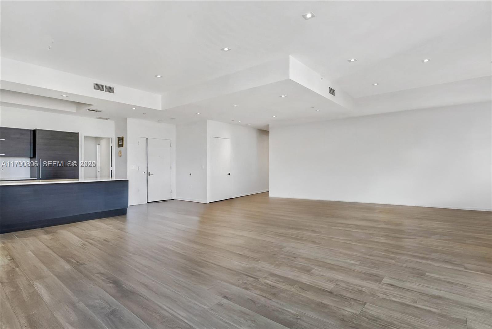 55 Southwest 9th Street, Unit PH4501 Miami, FL 33130 - Photo 6 of 71 a view of an empty room with wooden floor and a window