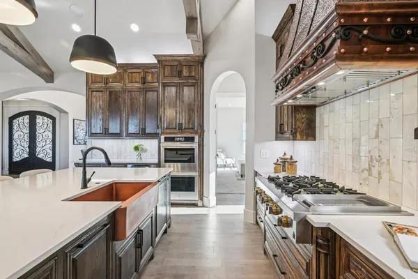 a kitchen with stainless steel appliances granite countertop a stove and a sink