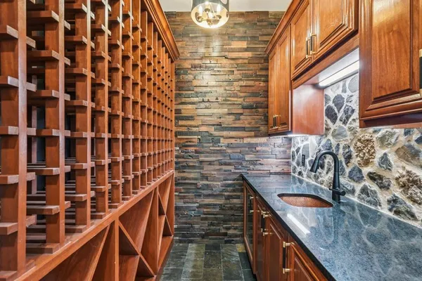 a bathroom with a granite countertop sink a mirror and shower