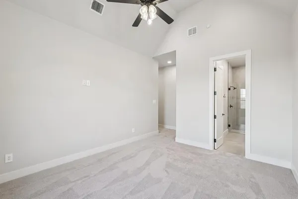 an empty room with fan and entrance