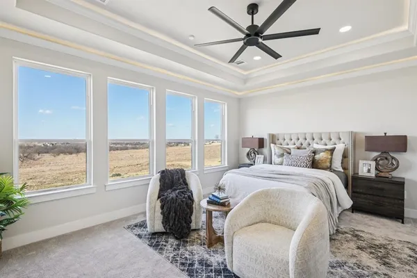 a spacious bedroom with a bed and a large window