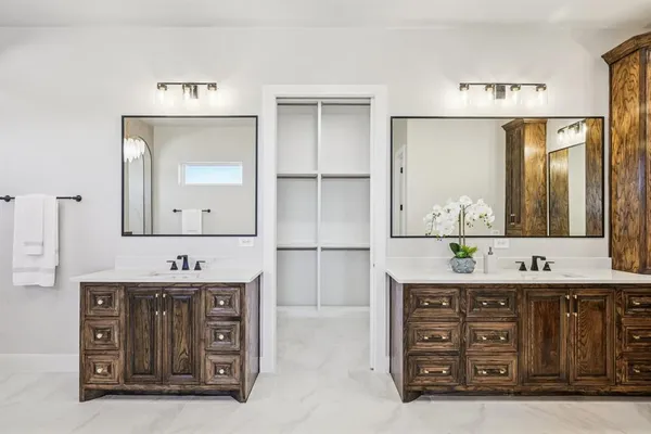 a bathroom with a double vanity sink and a mirror