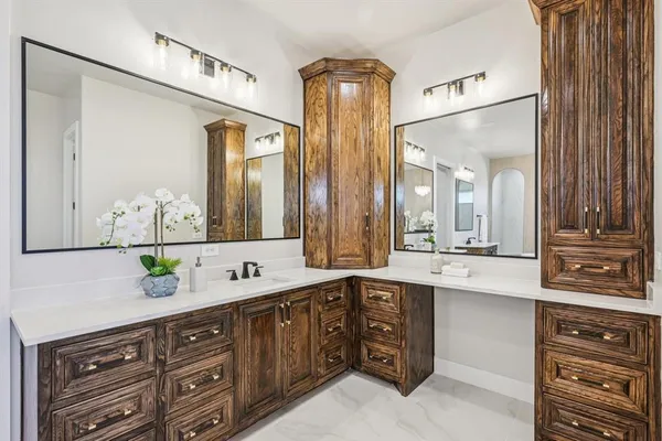 a spacious bathroom with double vanity and a mirror