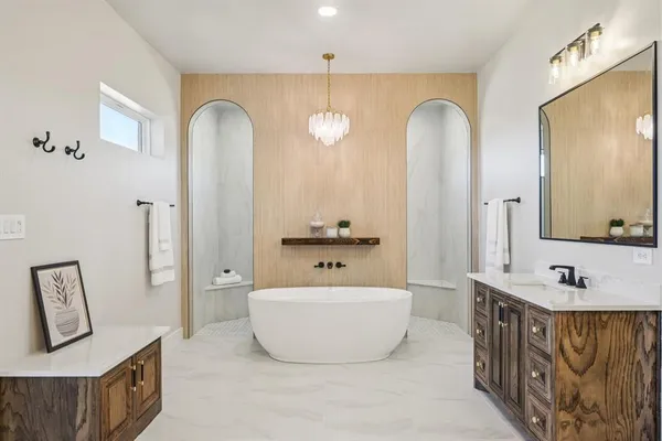 a bathroom with a tub sink and mirror