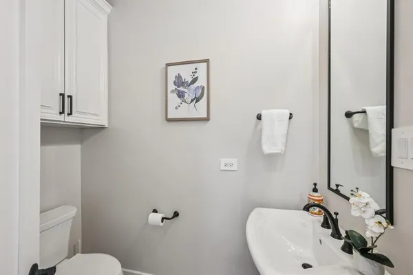 a bathroom with a sink mirror and toilet