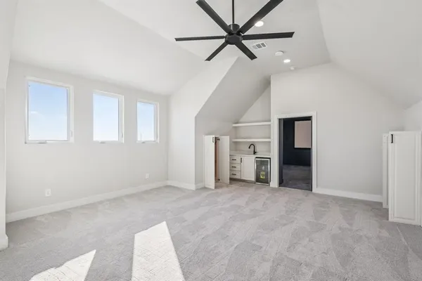 a view of a livingroom with a ceiling fan and window