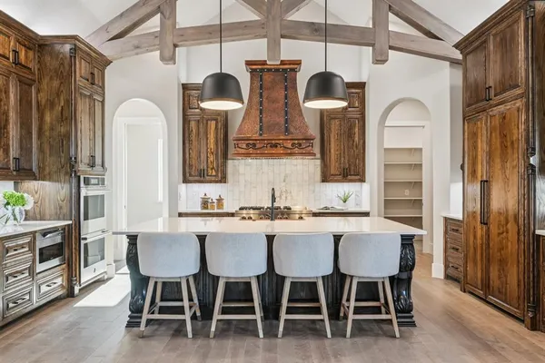 a dining room with chairs and view kitchen