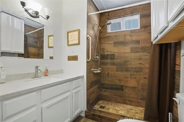 a bathroom with a toilet and a shower