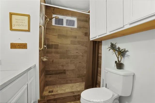 a view of a kitchen with wooden floor and a window