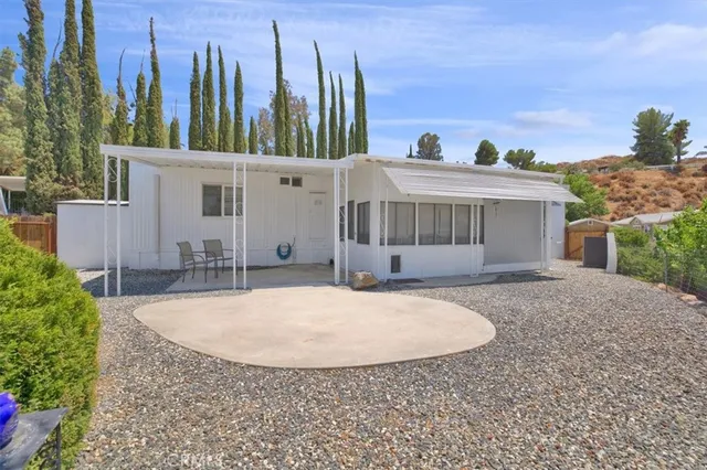 a view of a porch with furniture and garden