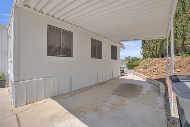 an aerial view of a town with swimming pool and mountains