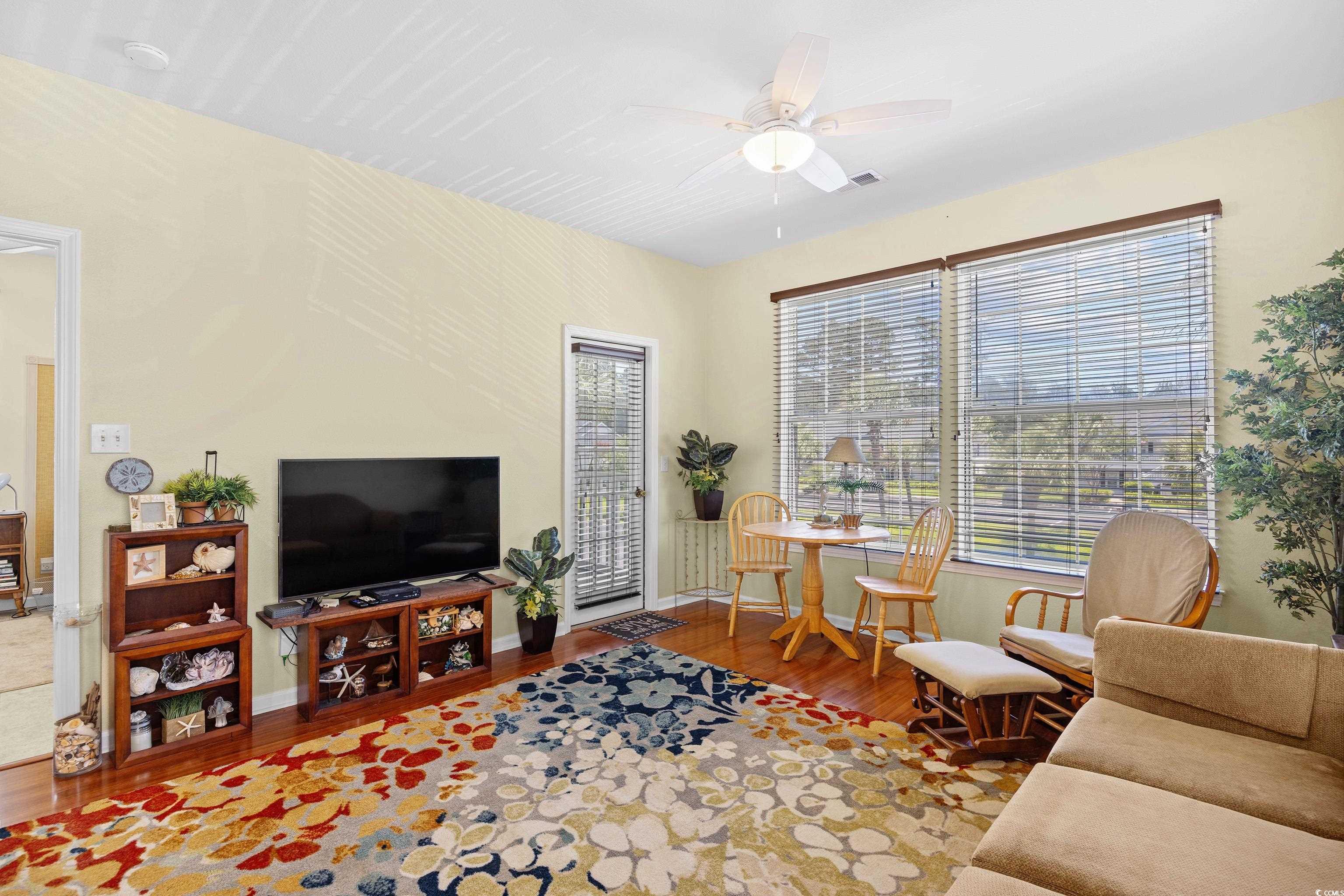 1298 River Oaks Drive, Unit 5J Myrtle Beach, SC 29579 - Photo 11 of 33 Living area with wood finished floors and a ceiling fan