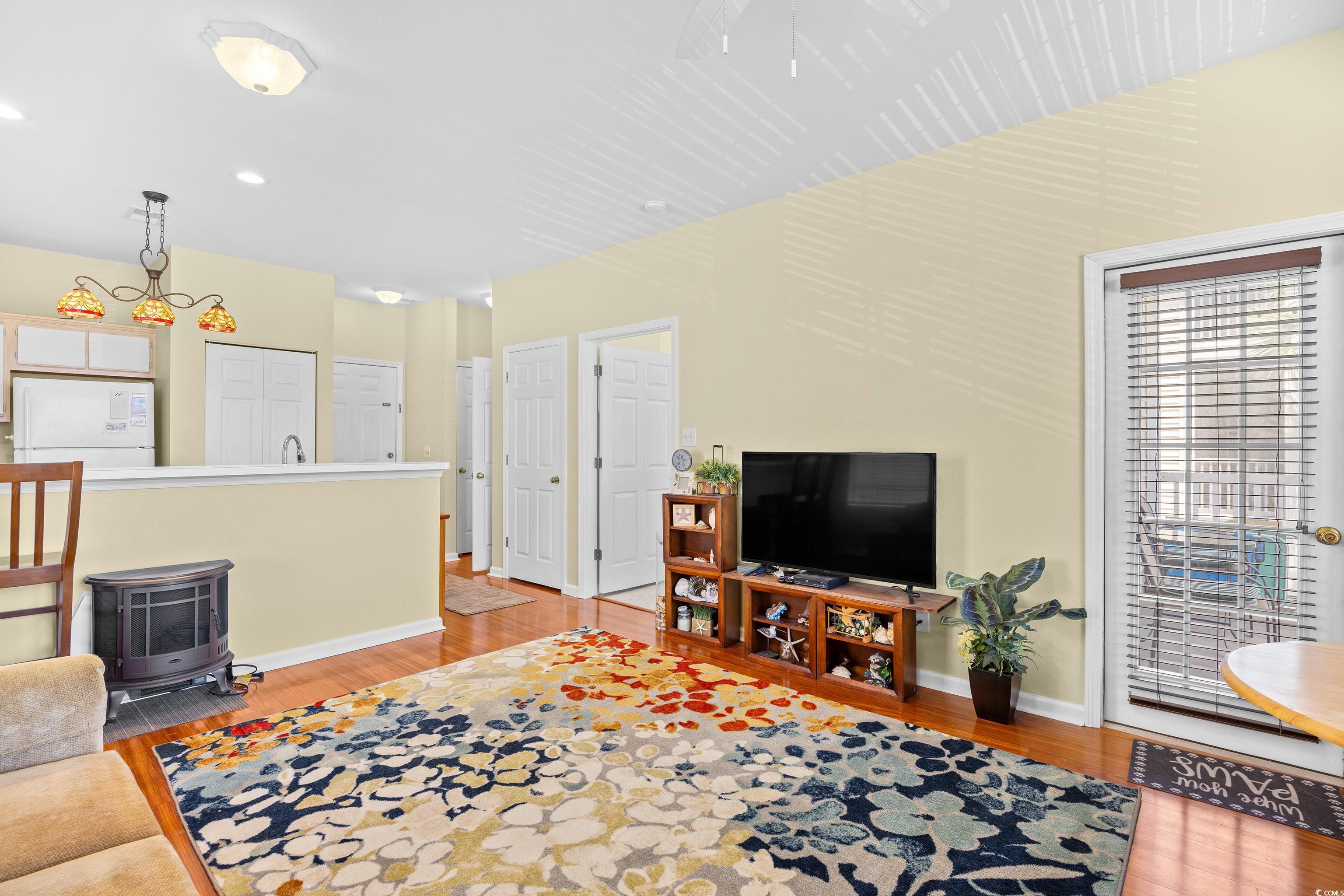 1298 River Oaks Drive, Unit 5J Myrtle Beach, SC 29579 - Photo 12 of 33 Living room featuring light wood-style floors, a wood stove, and recessed lighting