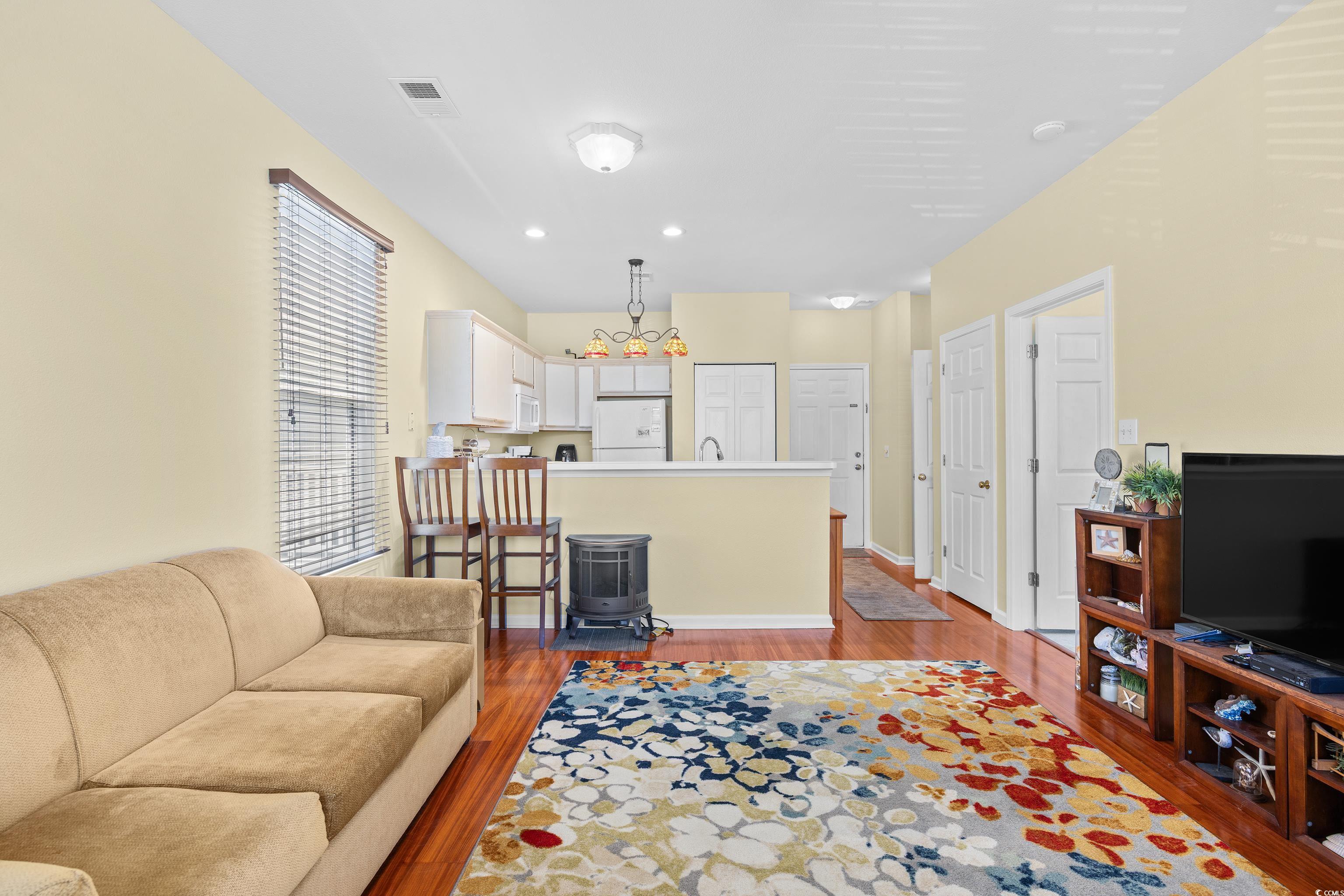 1298 River Oaks Drive, Unit 5J Myrtle Beach, SC 29579 - Photo 13 of 33 Living area with light wood-style flooring