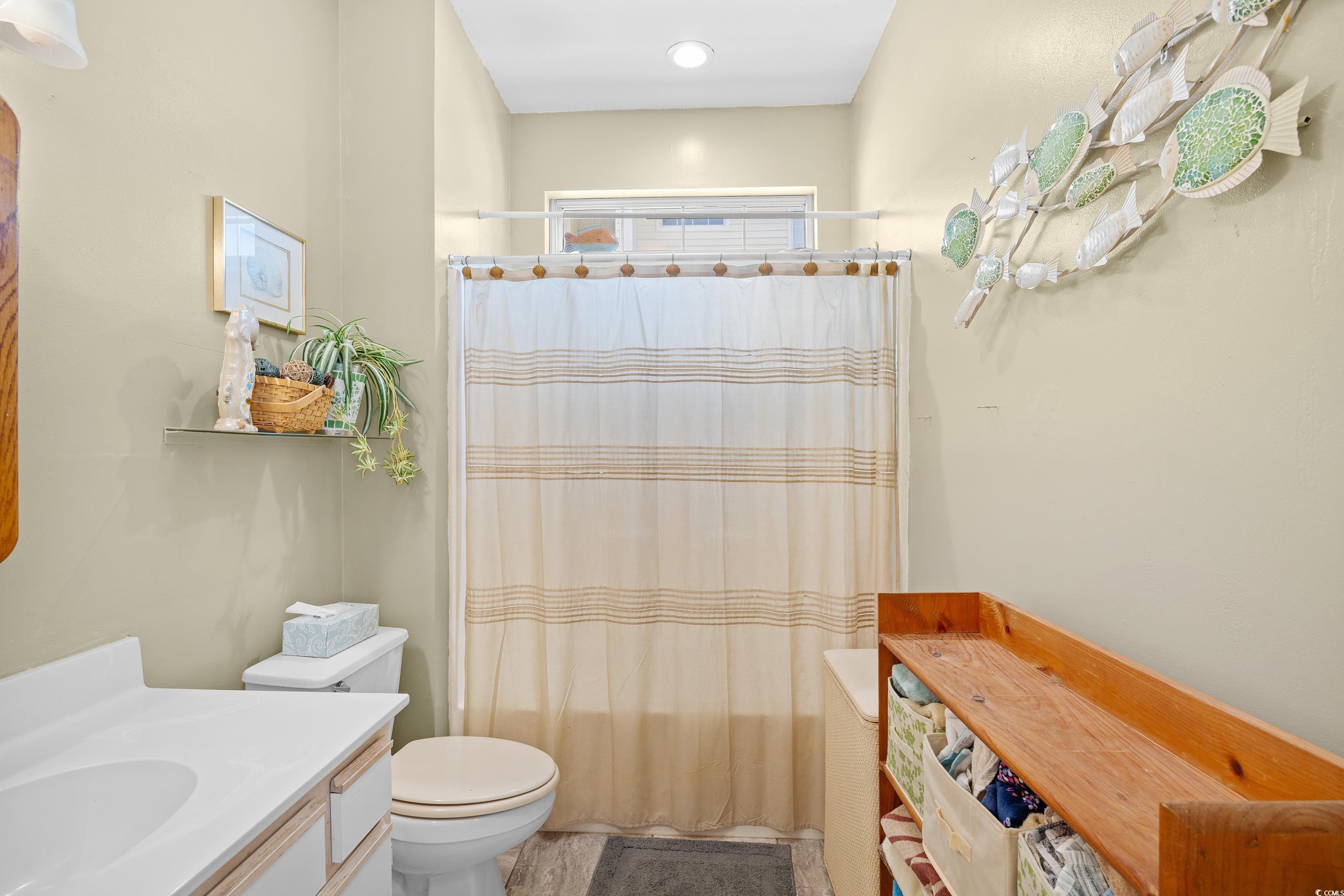 1298 River Oaks Drive, Unit 5J Myrtle Beach, SC 29579 - Photo 16 of 33 Bathroom featuring vanity and shower / bathtub combination with curtain