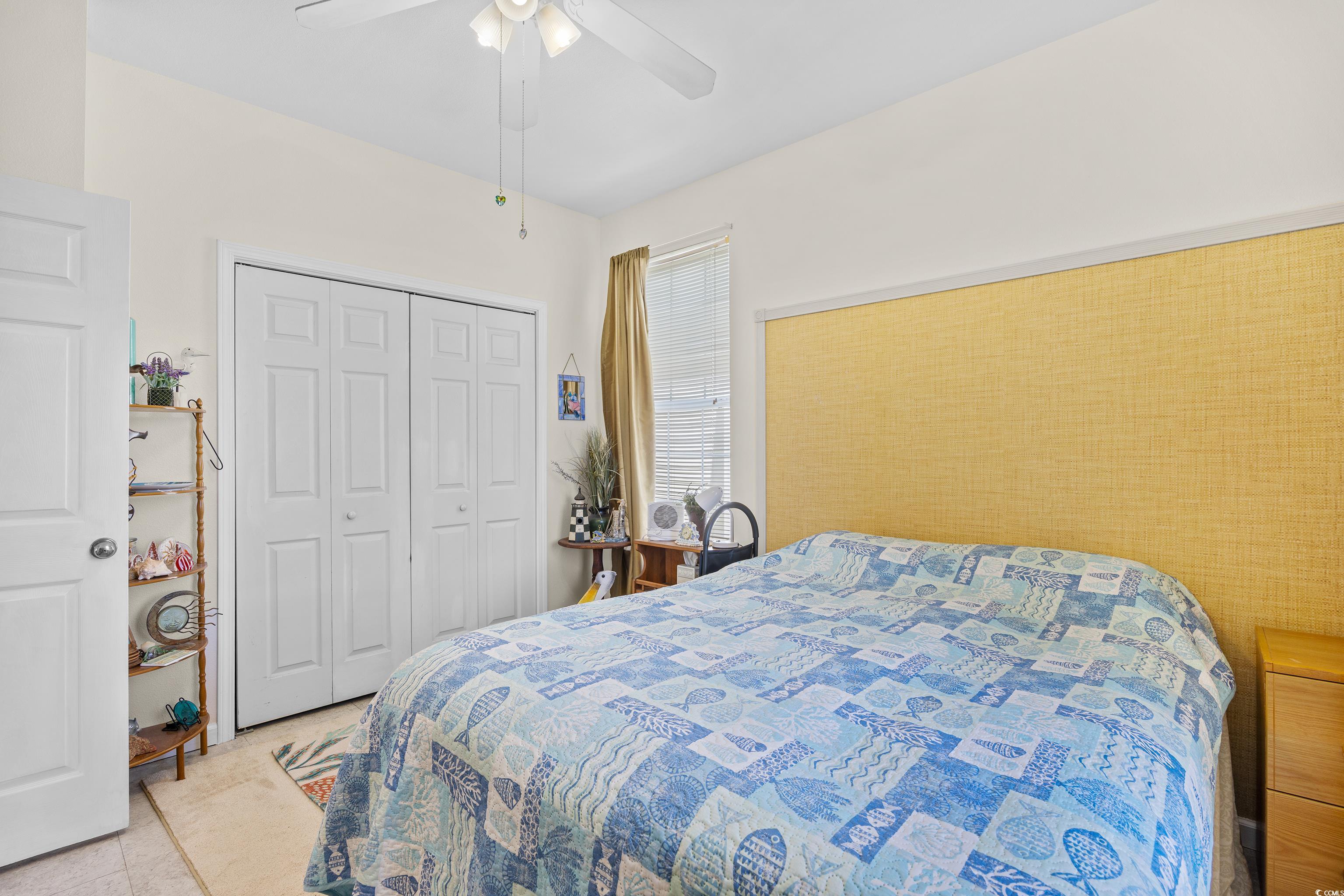 1298 River Oaks Drive, Unit 5J Myrtle Beach, SC 29579 - Photo 20 of 33 Bedroom featuring a closet and ceiling fan