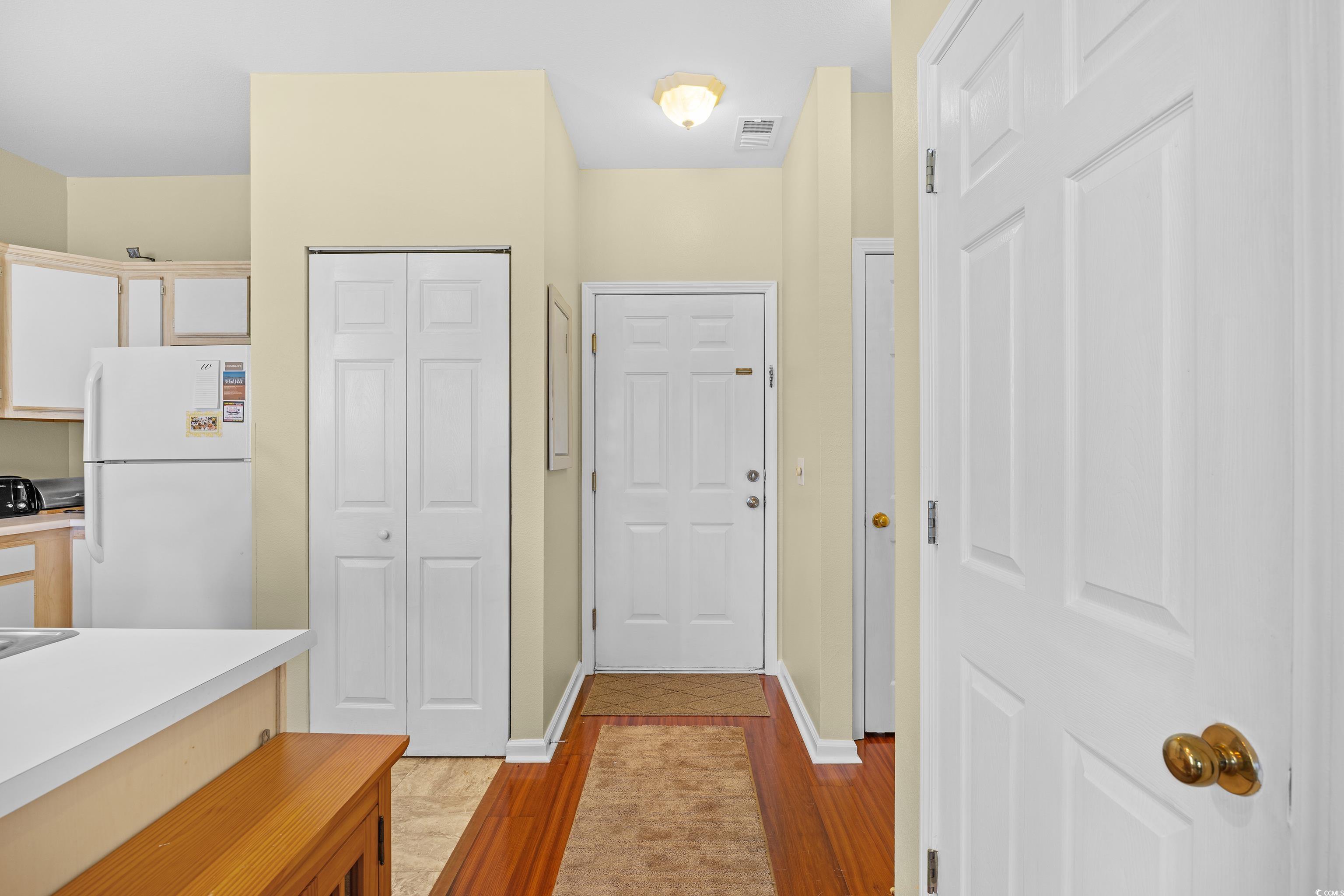1298 River Oaks Drive, Unit 5J Myrtle Beach, SC 29579 - Photo 2 of 33 Kitchen featuring freestanding refrigerator, light wood-type flooring, and light countertops