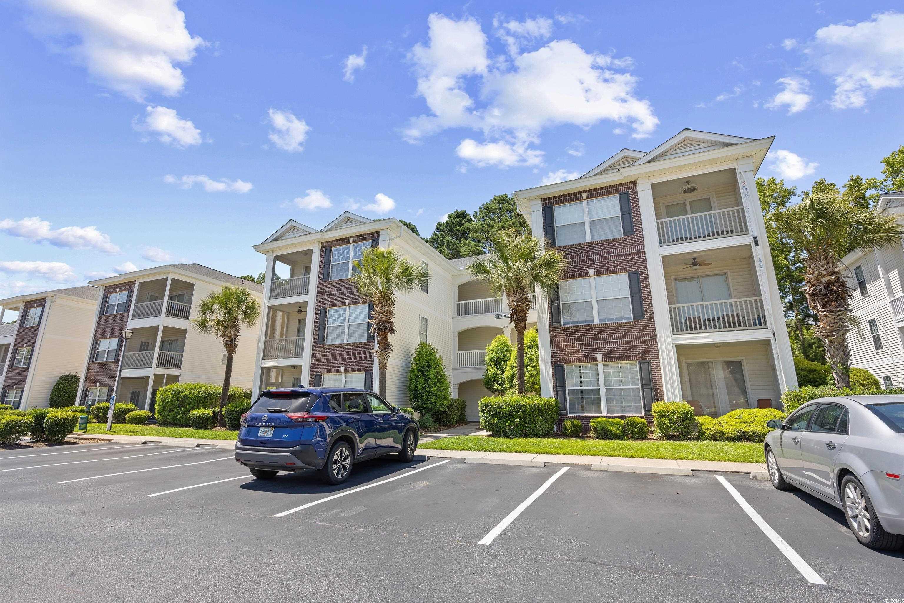1298 River Oaks Drive, Unit 5J Myrtle Beach, SC 29579 - Photo 28 of 33 View of building exterior with uncovered parking