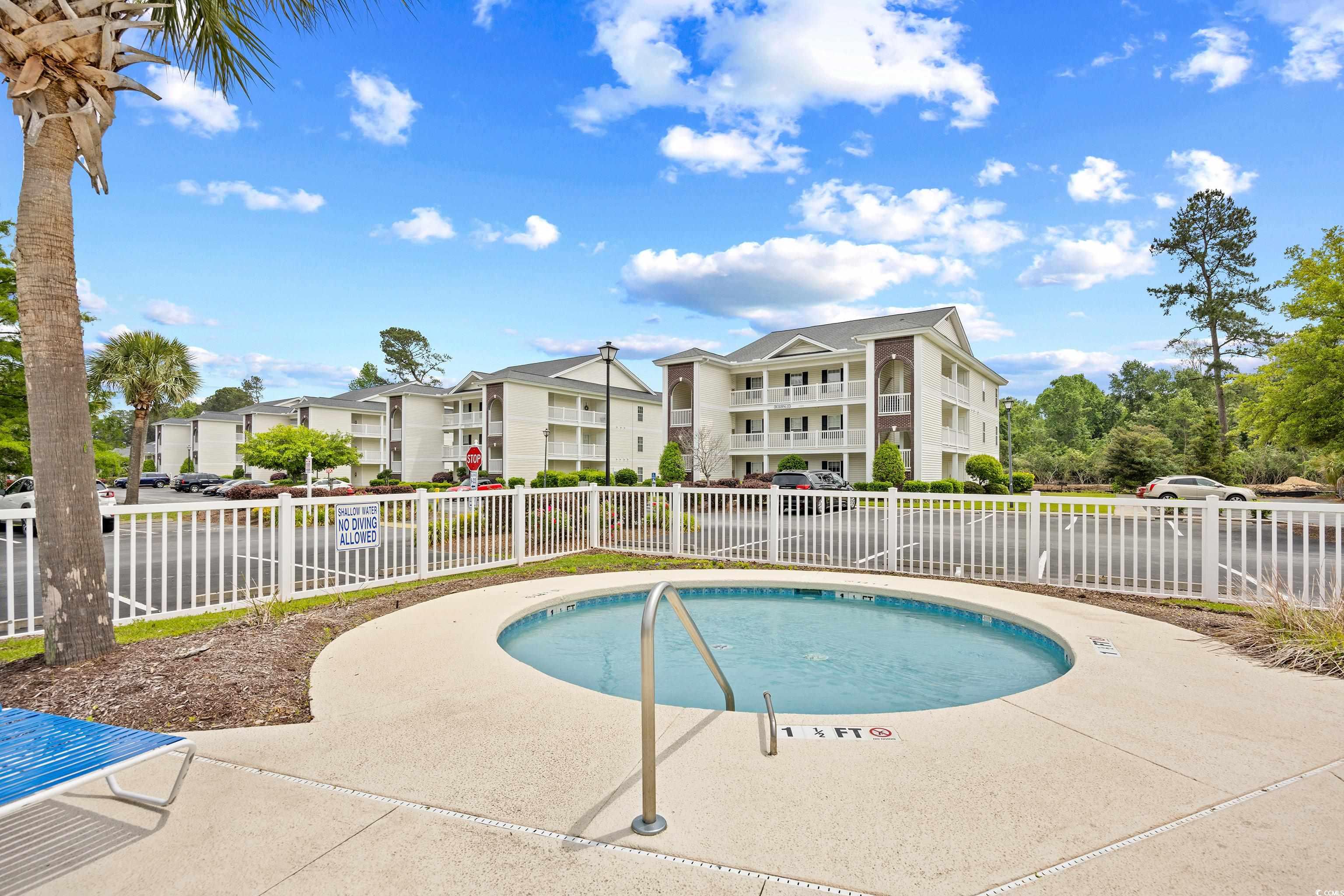 1298 River Oaks Drive, Unit 5J Myrtle Beach, SC 29579 - Photo 31 of 33 View of swimming pool featuring a community hot tub, a residential view, and a water view