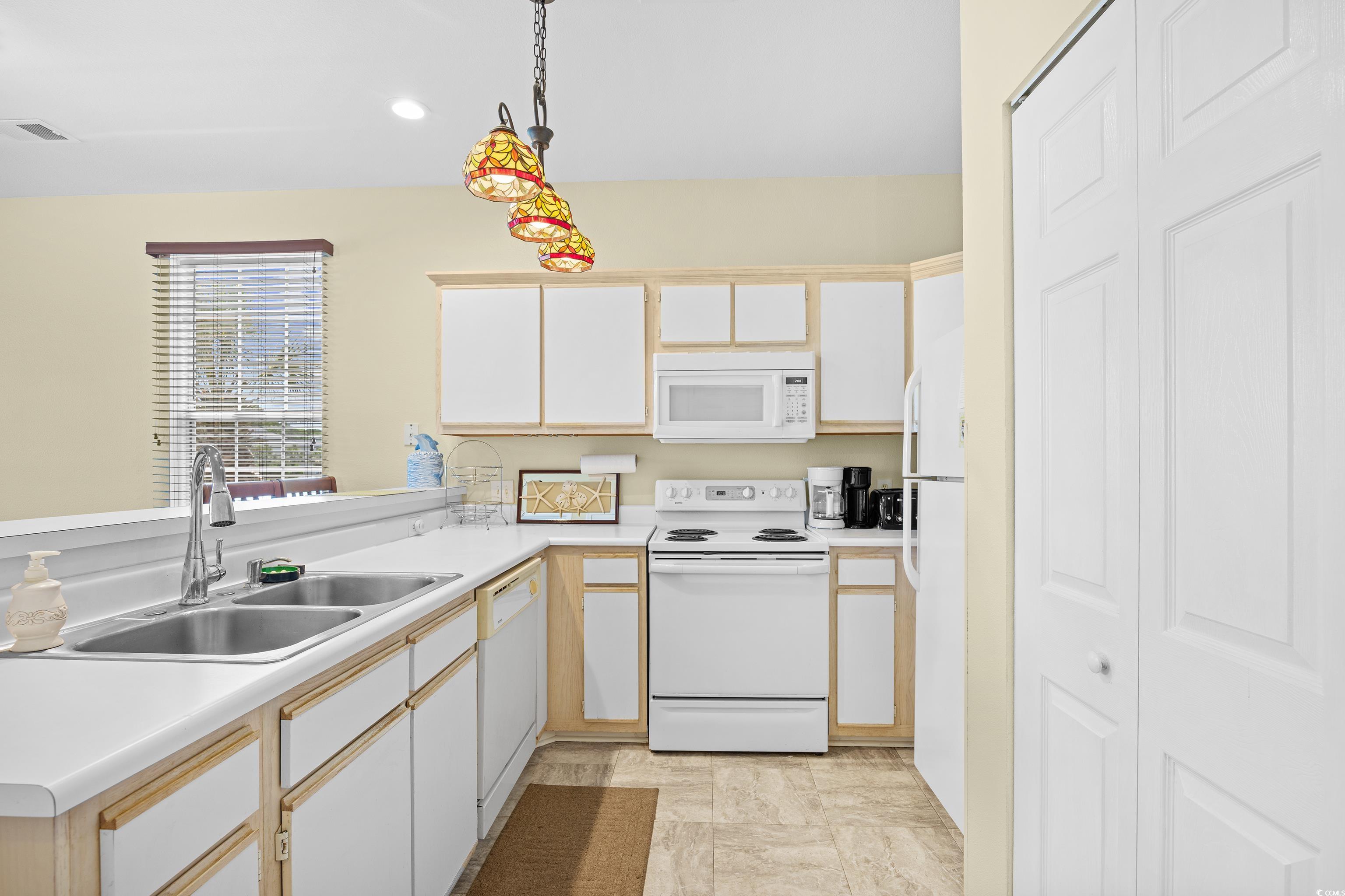 1298 River Oaks Drive, Unit 5J Myrtle Beach, SC 29579 - Photo 5 of 33 Kitchen with white appliances, light countertops, decorative light fixtures, and recessed lighting