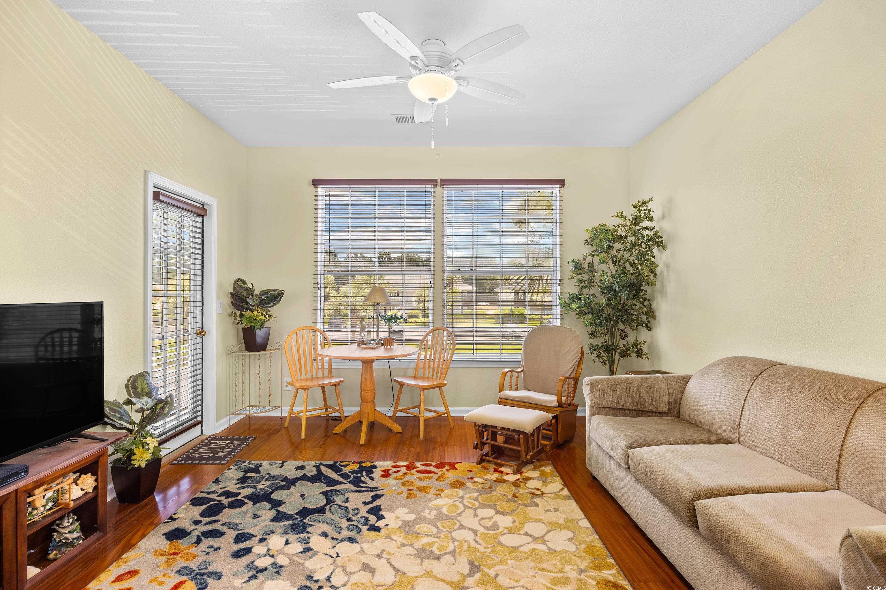 1298 River Oaks Drive, Unit 5J Myrtle Beach, SC 29579 - Photo 10 of 33 Living area featuring wood finished floors and ceiling fan