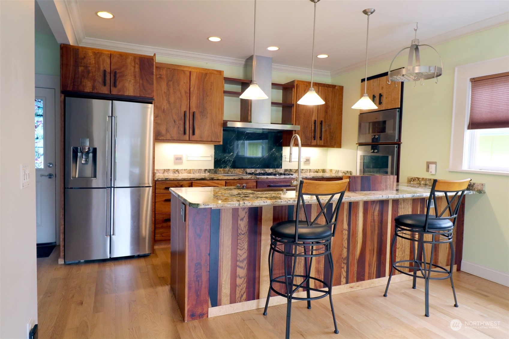 1908 4th Street Bremerton, WA 98337 - Photo 10 of 34 a kitchen with stainless steel appliances granite countertop a refrigerator a stove a sink a dining table and chairs with wooden floor