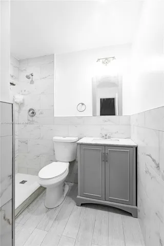 a bathroom with a toilet sink and shower