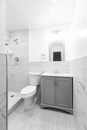 a bathroom with a toilet sink and mirror