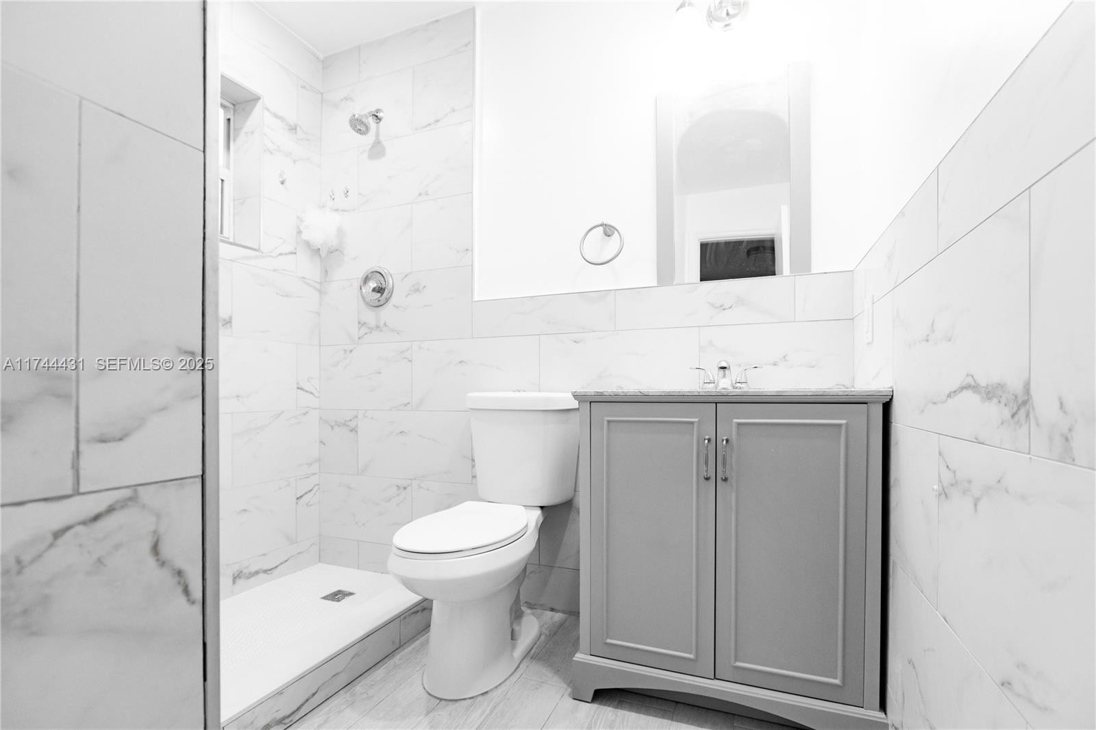 1060 Northeast 78th Street, Unit 5 Miami, FL 33138 - Photo 13 of 17 a bathroom with a sink a toilet and shower