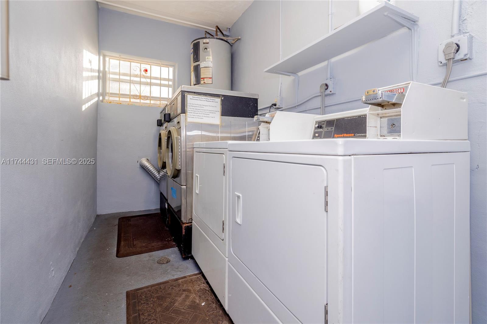 1060 Northeast 78th Street, Unit 5 Miami, FL 33138 - Photo 15 of 17 a view of storage and utility room with washer and dryer