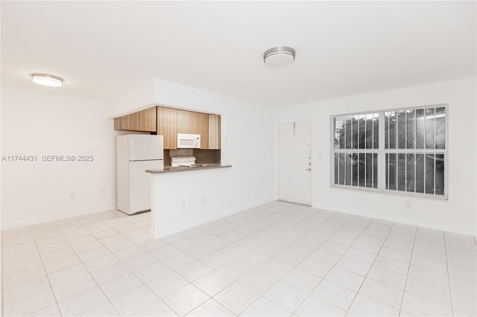 1060 Northeast 78th Street, Unit 5 Miami, FL 33138 - Photo 2 of 17 a view of a kitchen with cabinet and windows