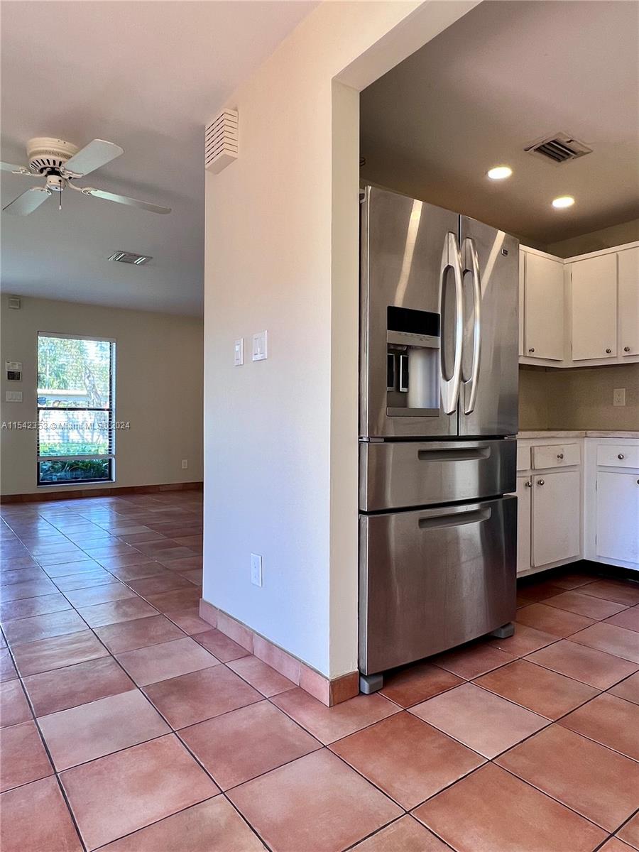 11353 Southwest 109th Road, Unit 55Z Miami, FL 33176 - Photo 21 of 82 a kitchen with kitchen island a counter top space appliances and a ceiling fan