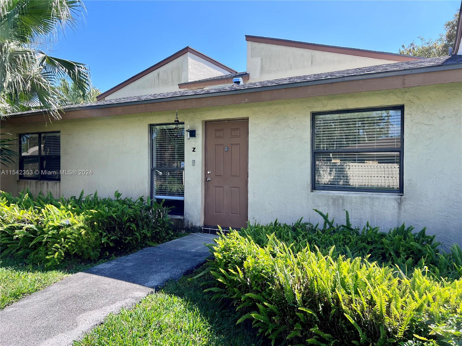 11353 Southwest 109th Road, Unit 55Z Miami, FL 33176 - Photo 3 of 82 a front view of a house with garden