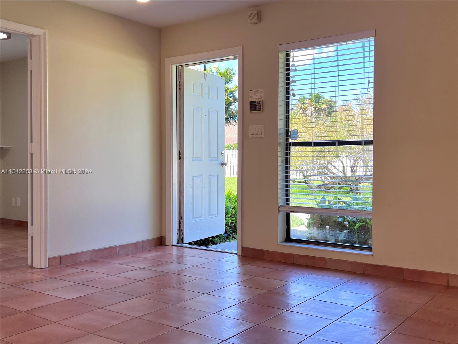 11353 Southwest 109th Road, Unit 55Z Miami, FL 33176 - Photo 39 of 82 an empty room with windows and entrance