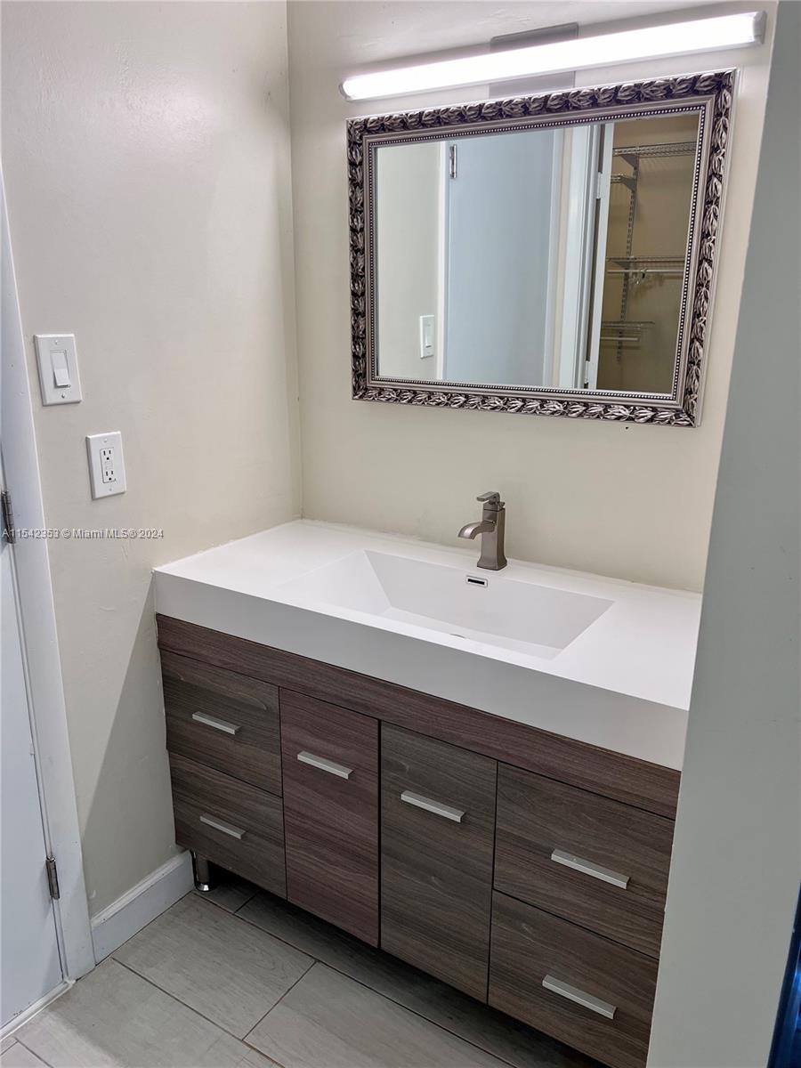 11353 Southwest 109th Road, Unit 55Z Miami, FL 33176 - Photo 44 of 82 a bathroom with a sink a vanity and a mirror