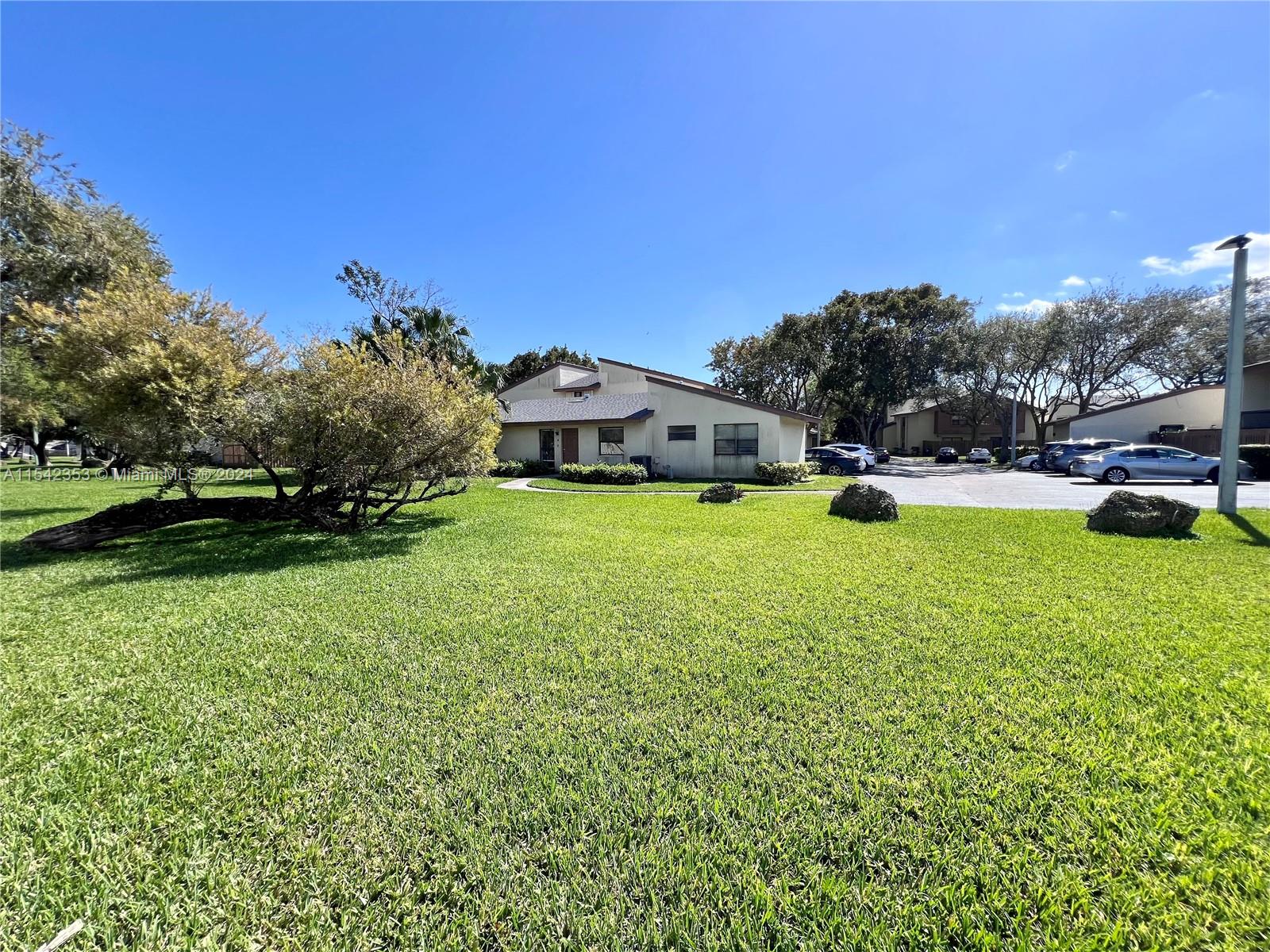 11353 Southwest 109th Road, Unit 55Z Miami, FL 33176 - Photo 52 of 82 a view of a house with a big yard and large trees