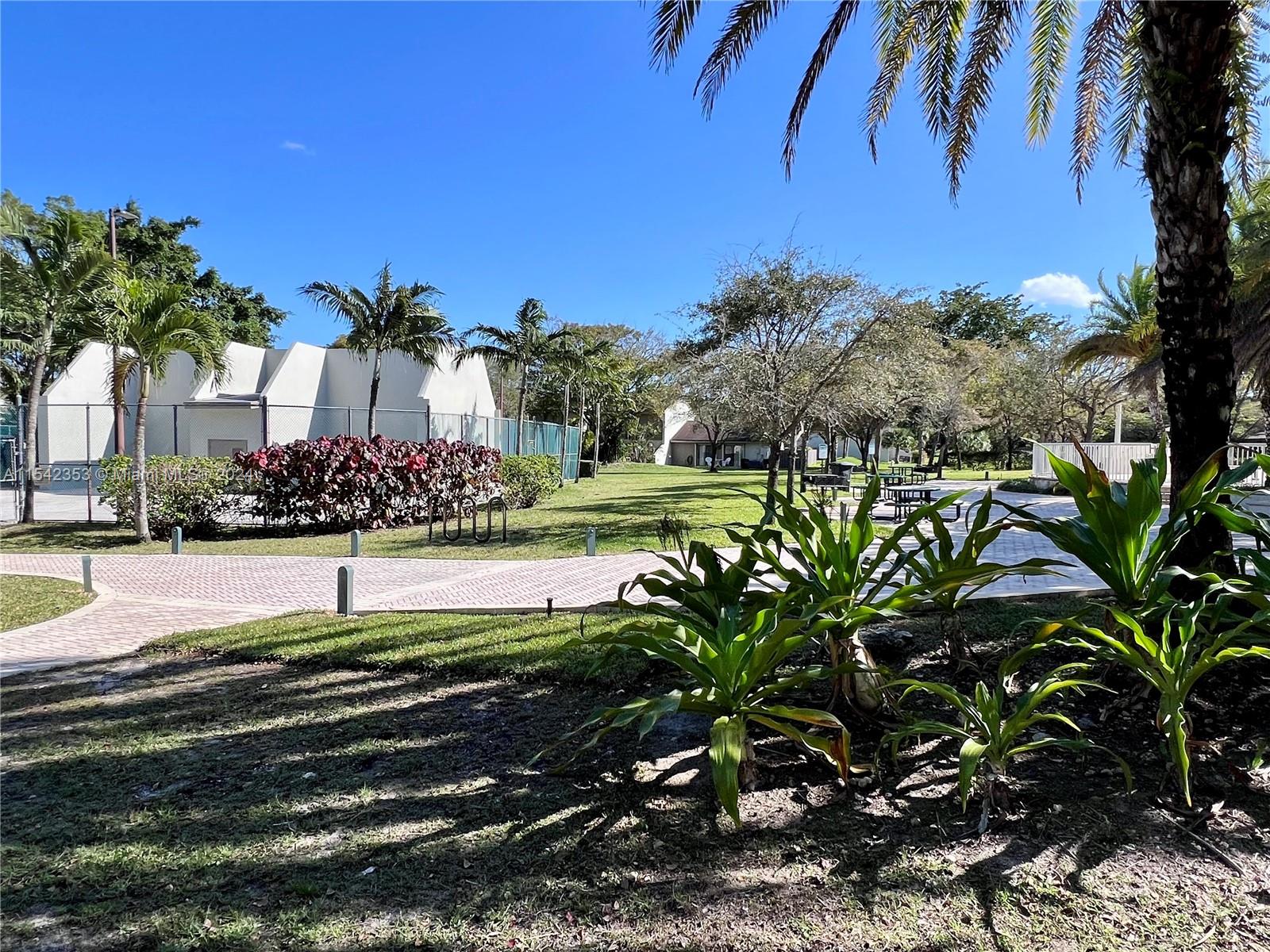 11353 Southwest 109th Road, Unit 55Z Miami, FL 33176 - Photo 73 of 82 a view of a yard with palm trees