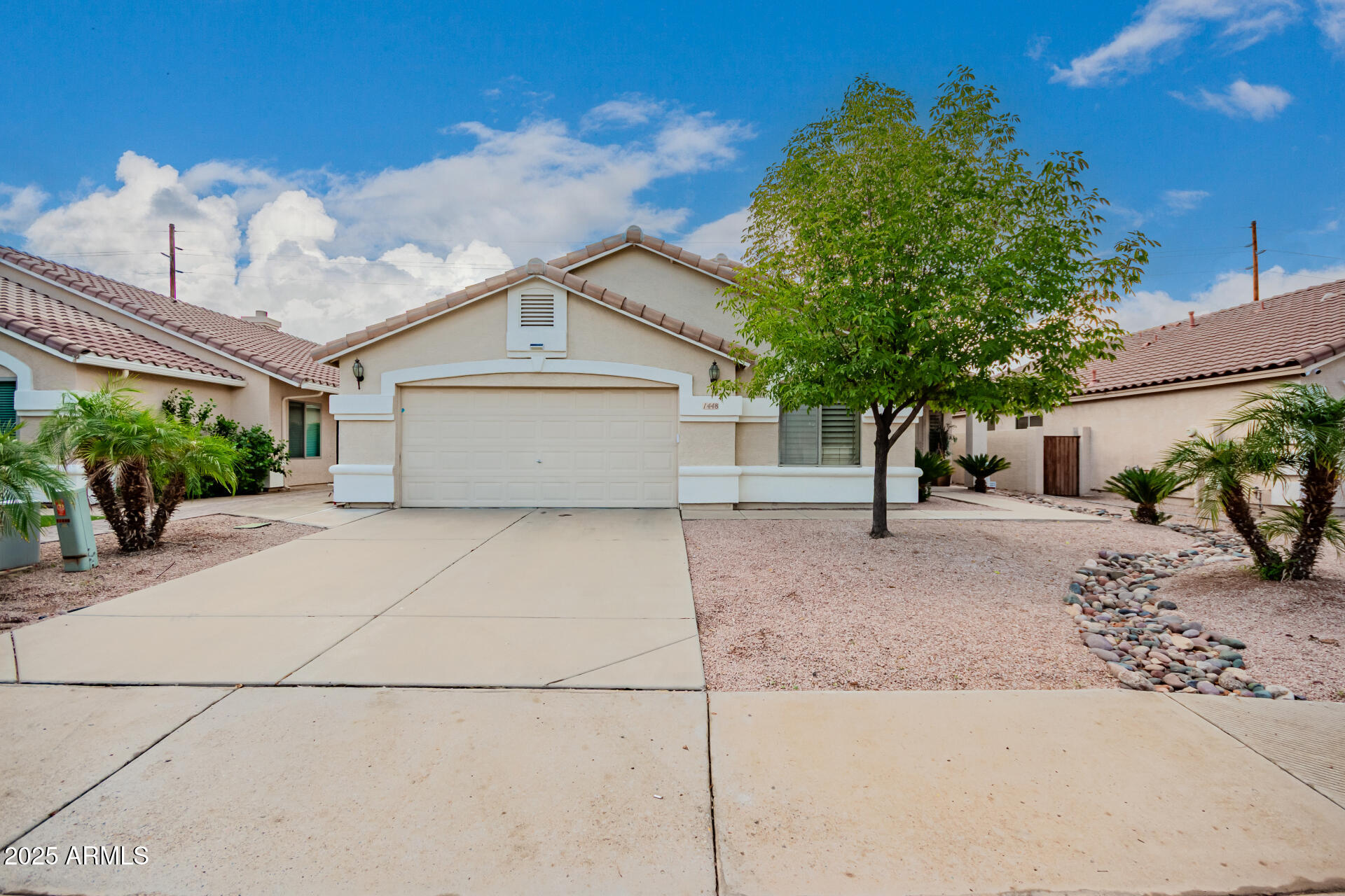 1448 North Saddle Street Gilbert, AZ 85233 - Photo 1 of 34 a front view of a house with a yard and a garage