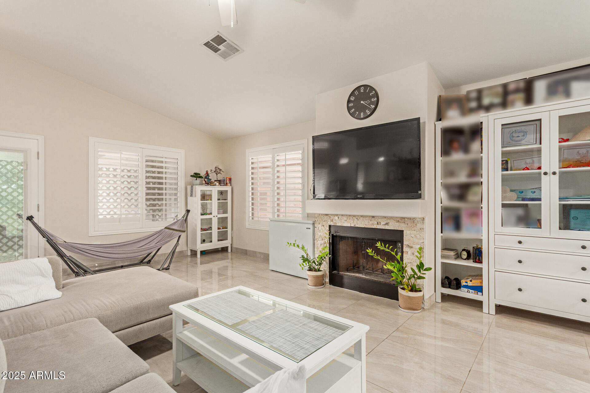 1448 North Saddle Street Gilbert, AZ 85233 - Photo 11 of 34 a living room with furniture a flat screen tv and a fireplace