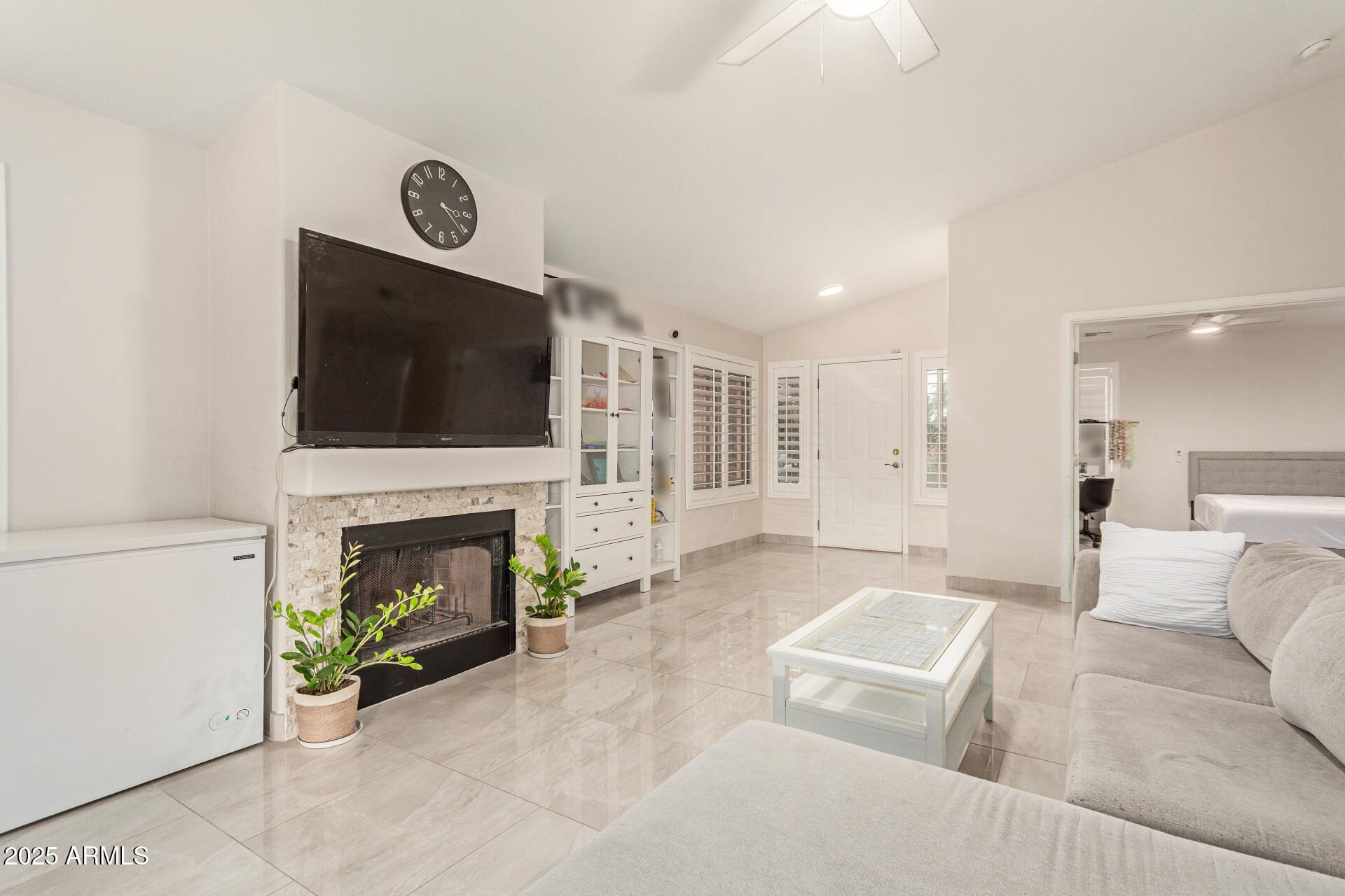 1448 North Saddle Street Gilbert, AZ 85233 - Photo 12 of 34 a living room with furniture a flat screen tv and a fireplace