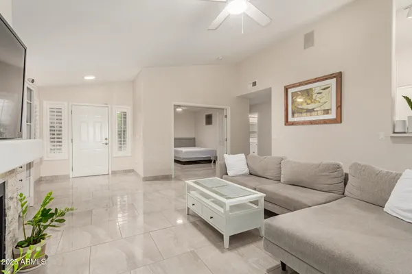 a living room with furniture and a large mirror